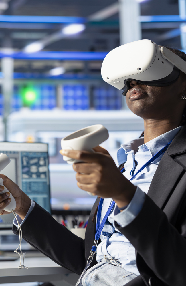 Engineer in photovoltaics factory using virtual reality equipment to diagnose malfunctioning systems. African american solar panels plant worker using VR headset to reduce downtime